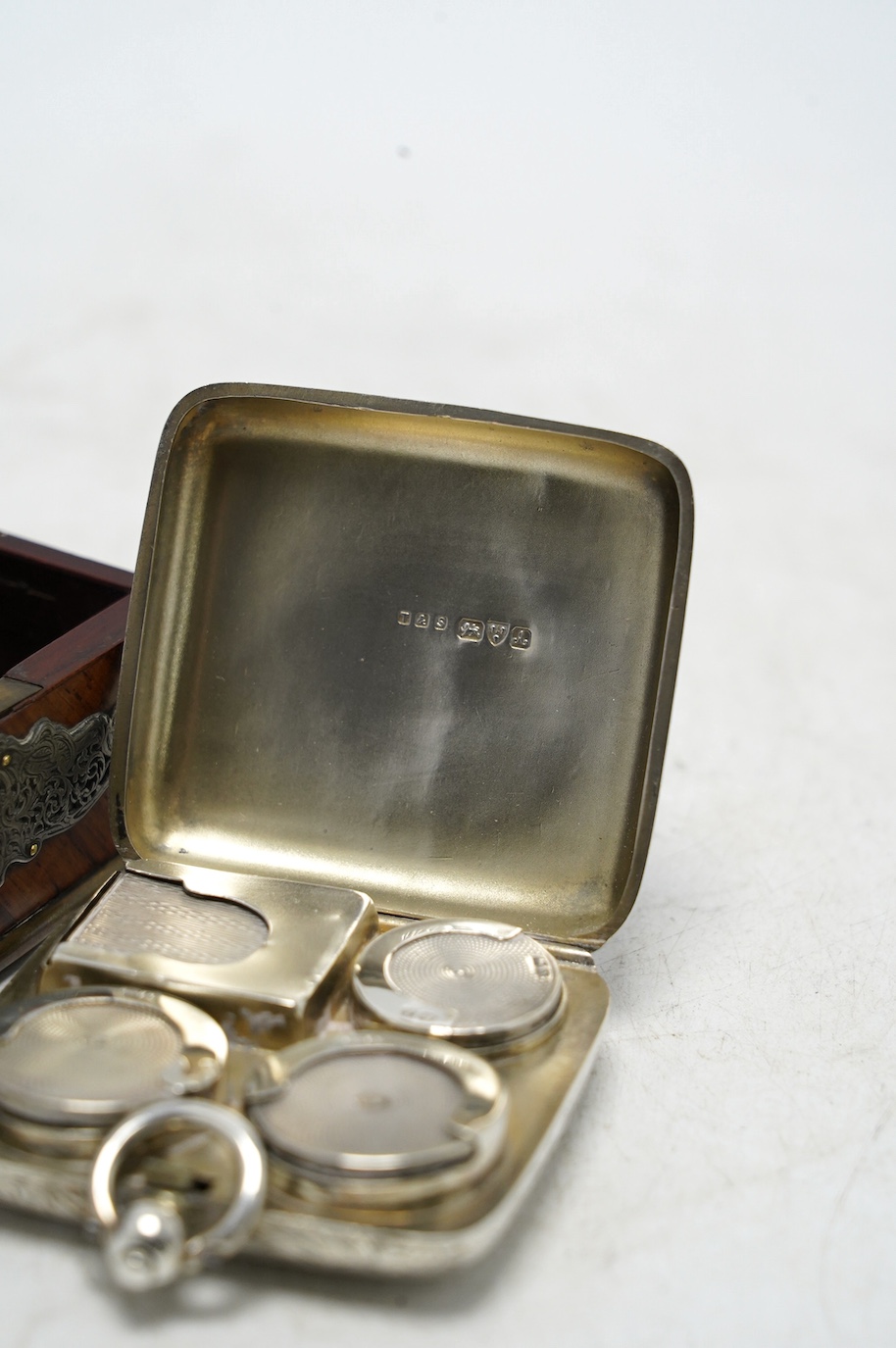 An Edwardian engraved silver combination sovereign/half sovereign and stamp case, E.J. Trevitt & Sons, Chester, 1901, 57mm and a white metal mounted kingwood snuff box. Condition - fair to good